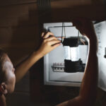 Emergency,Power,Outage,In,House.,Woman,With,Flashlight,Looks,Into