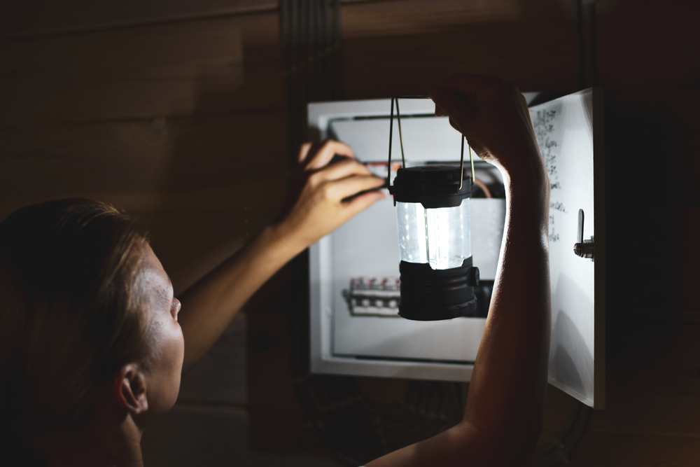Emergency,Power,Outage,In,House.,Woman,With,Flashlight,Looks,Into