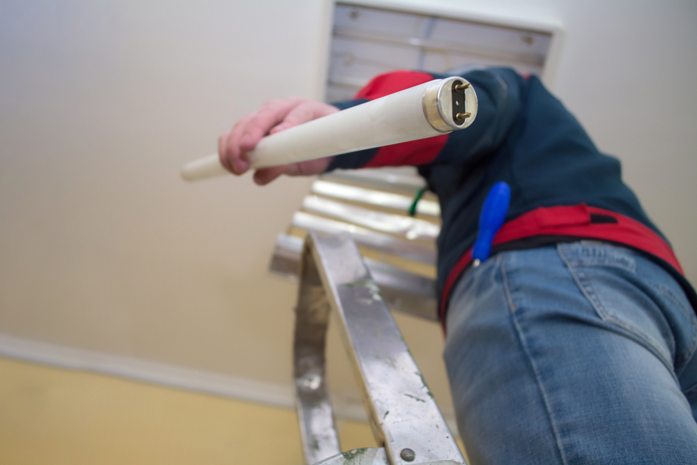 Electrician,Man,Worker,In,Uniform,Installing,Ceiling,Fluorescent,Lamp