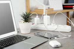 Smartphone,Charging,With,Cable,On,Light,Stone,Table